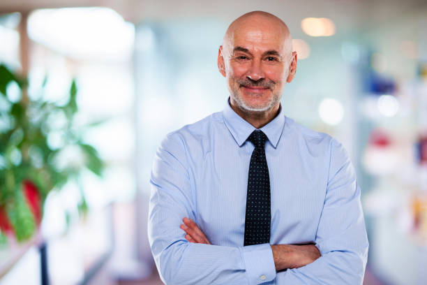 istock Middle aged businessman standing at the office 1447400709