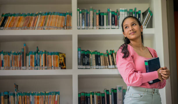 istock young university student in the library reading a book, student doing research at the library 1447401573