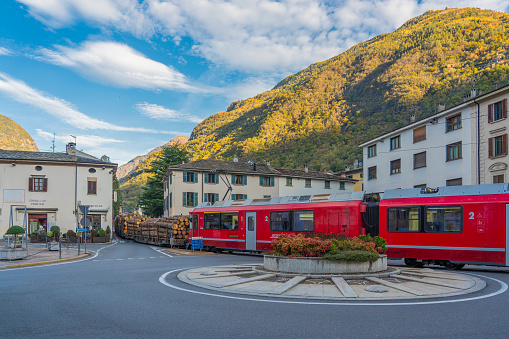 Bernina Express of Rhaetian Railway line driving through town Tirano, Italy,