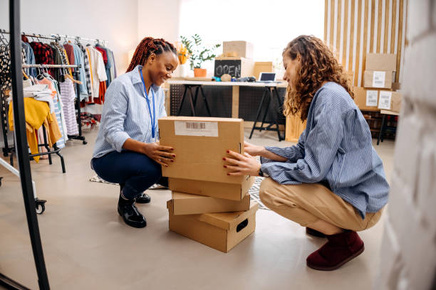 istock Two women preparing packages for shipping 1447404035