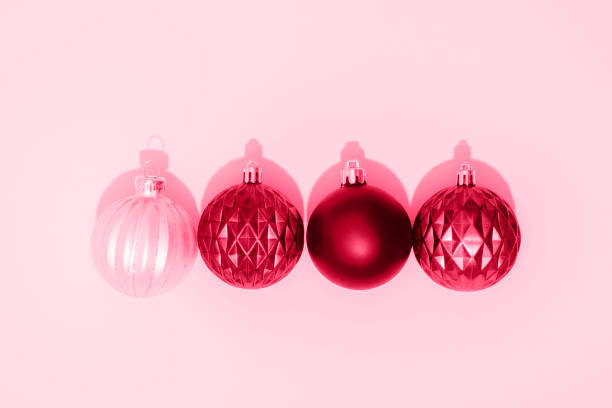 istock Viva magenta Christmas balls on pink background with sharp shadows. Top view, flat lay 1447404366