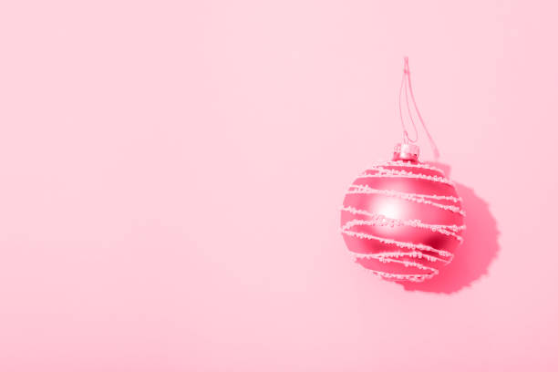 istock Christmas ball on pink background with sharp shadow. Top view, flat lay, copy space 1447404381