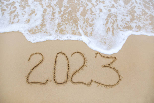 istock 2023 year written on sandy beach sea. 1447406666