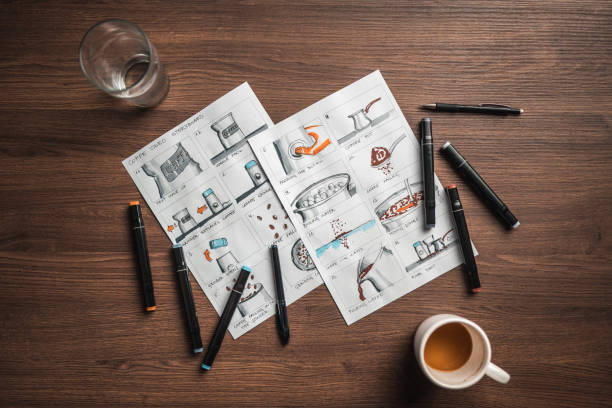 istock Storyboard Editors Table; Coffee, Colored Pencils And A Smartphone 1447408588