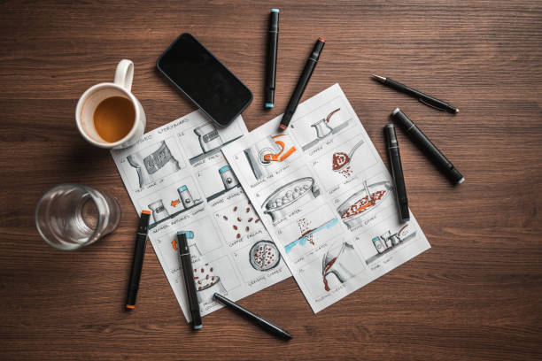 istock Storyboard Editors Table; Coffee, Colored Pencils And A Smartphone 1447408589
