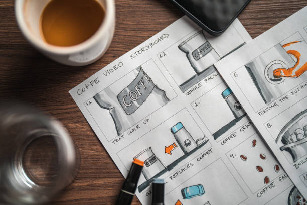 istock Storyboard Editors Table; Coffee, Colored Pencils And A Smartphone 1447408597