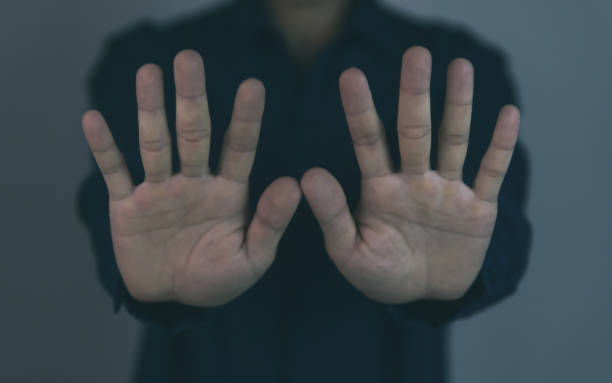 istock A man raises his hands to stop the violence. 1447411158