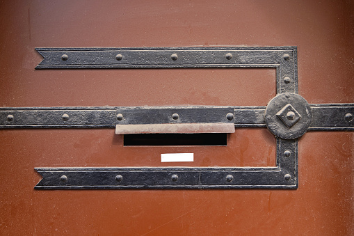 Letter Box Mail Slot at Old Brown Door With Ironwork