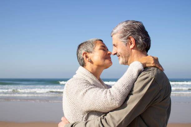 istock Romantic senior couple hugging at seashore 1447412333