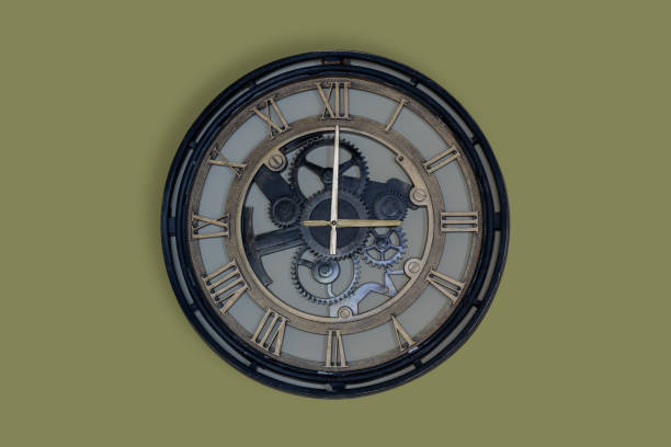 istock Classic  analog clock on yellow - green wall background at three  o'clock with copy space 1447412851