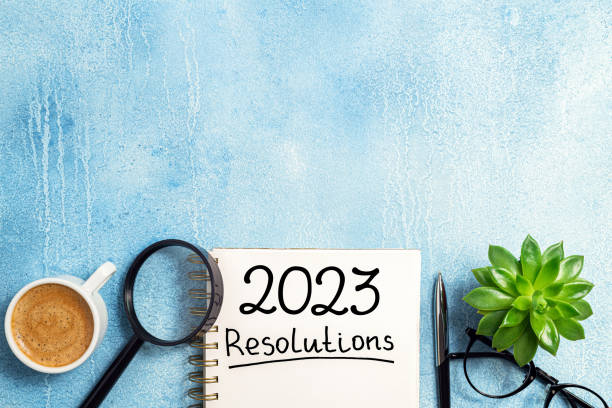 istock New year resolutions 2023 on desk. 2023 resolutions list with notebook, coffee cup on table. Goals, resolutions, plan, action, checklist concept. New Year 2023 template 1447413220