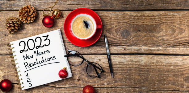 istock New year resolutions 2023 on desk. 2023 resolutions list with notebook, coffee cup, decorations on table. Goals, resolutions, plan, action concept. New Year 2023 background 1447413236