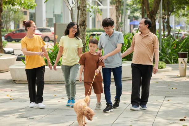 istock Family Walking in Park 1447413328