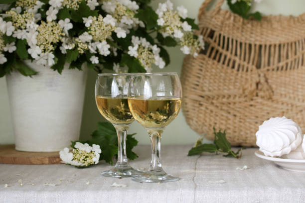 istock Glasses of white wine on the table. Cottage core. 1447414459