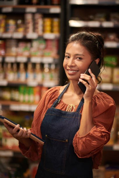 istock Supermarket Worker Accepting Order on Phone 1447414616