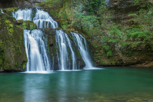 istock Waterfall from the source of the Lison in a haven of peace with its waterfall surrounded by forest. 1447416095