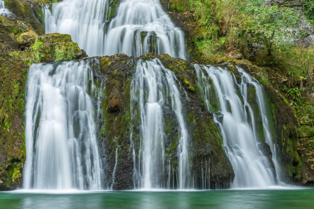 istock Waterfall from the source of the Lison in a haven of peace with its waterfall surrounded by forest. 1447416146