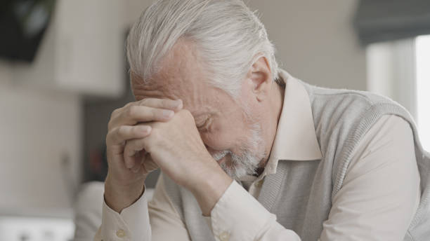 istock Unhappy senior man sitting in room alone, upset with a problem, loneliness 1447417356