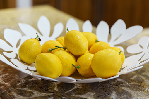 Lemons in Tray on Kitchen Counter Top Decor - Design element in home. Selective focus on foreground.