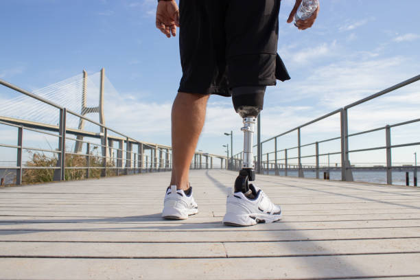 istock Back view of man with mechanical leg on sunny day 1447417924
