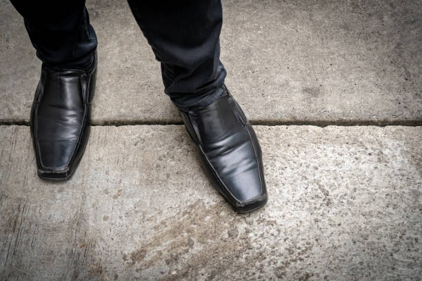 istock Standing leg with the black leather feet classic 1447419450