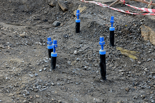the puller of the water valves in the street. the newly built water supply system has blue metal caps on entire streets and individual houses about a meter deep under the asphalt. renovation, repairs, broken pipe, fittings, hdpe pipes, leakage, plumbing, tap, puller