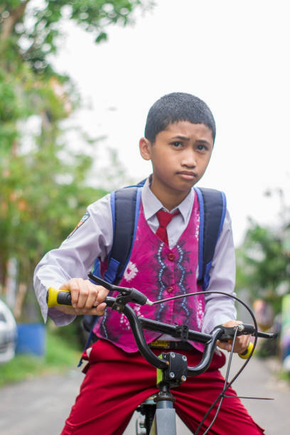 istock Indonesian students in uniform go to school by bicycle 1447419550