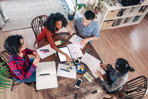 istock four business people sharing lunchon table in meeting 1447419914