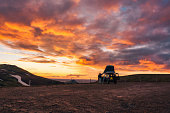 Camper car parked with sunset sky on top of mountain in Icelandic Highlands on summer at Iceland