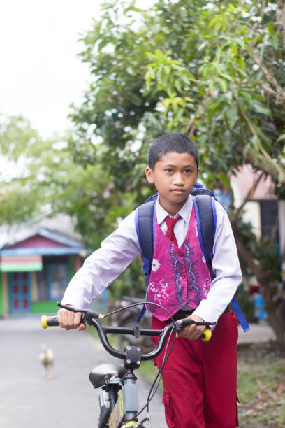 istock Indonesian students in uniform go to school by bicycle 1447420766
