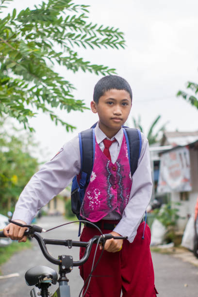 istock Indonesian students in uniform go to school by bicycle 1447420769