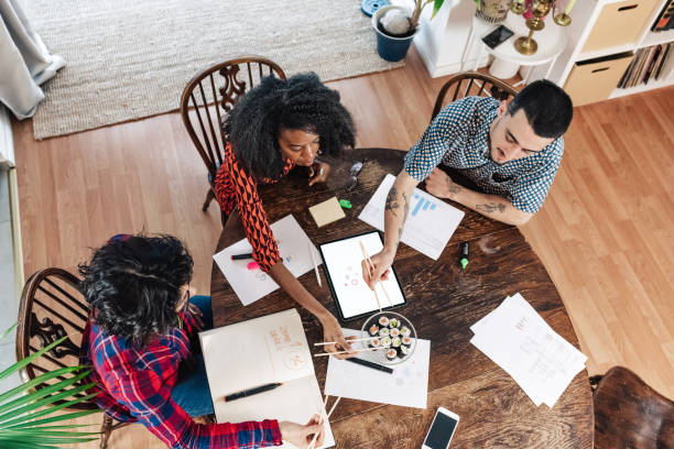 istock business people sharing lunch on business table 1447420779