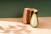 Composition empty podium material wood stone avocado. Product presentation. The background is beige-green. Beautiful background from natural materials.
