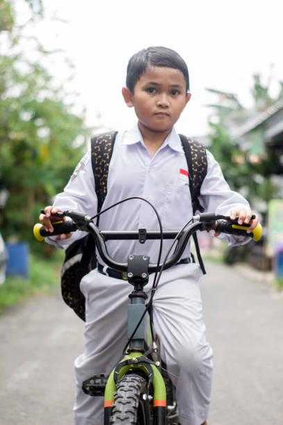 istock Indonesian students in uniform go to school by bicycle 1447422980
