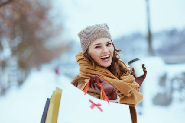 istock smiling modern woman in brown hat and scarf 1447423402