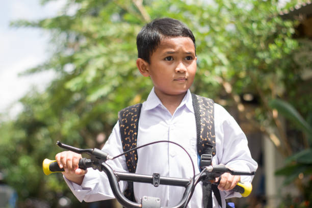 istock Indonesian students in uniform go to school by bicycle 1447423423