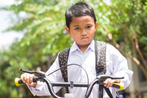 istock Indonesian students in uniform go to school by bicycle 1447423428