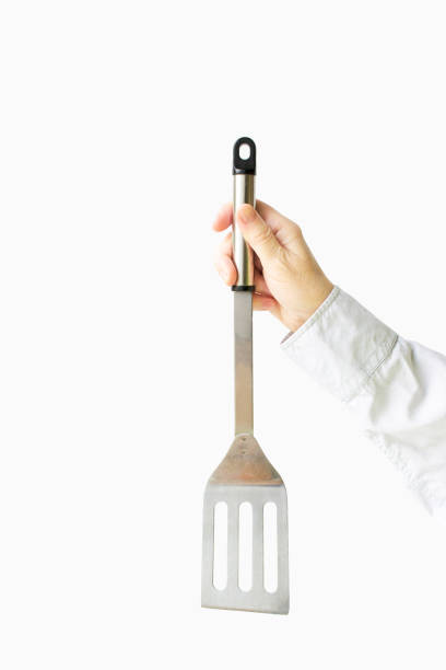 istock Barbecue spatula in female hands isolated on a white background 1447423837