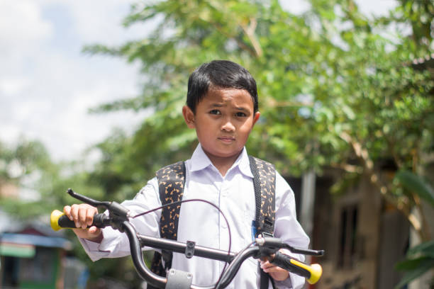 istock Indonesian students in uniform go to school by bicycle 1447424825