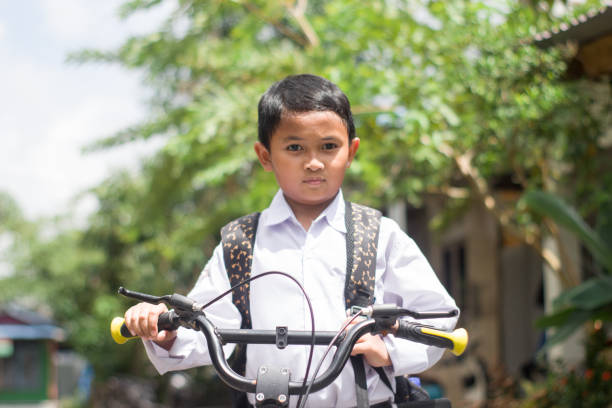 istock Indonesian students in uniform go to school by bicycle 1447424990