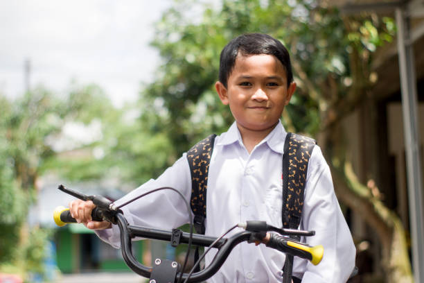 istock Indonesian students in uniform go to school by bicycle 1447426626