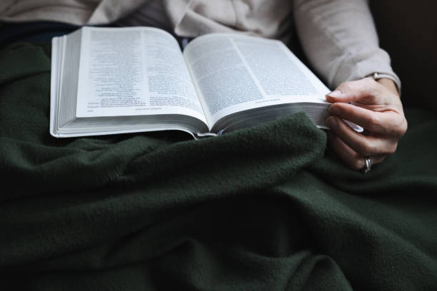 istock Reading the bible with cozy green blanket 1447427014
