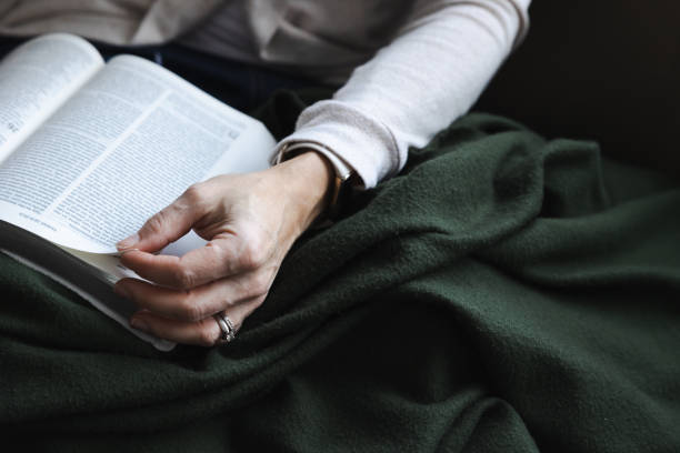 istock Reading the bible with a warm blanket 1447427015