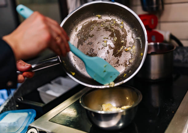 istock man chef cooking tasty scrambled eggs in frying pan on kitchen 1447430830