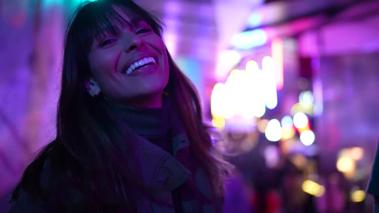 Portrait of a happy young woman in a festival at night