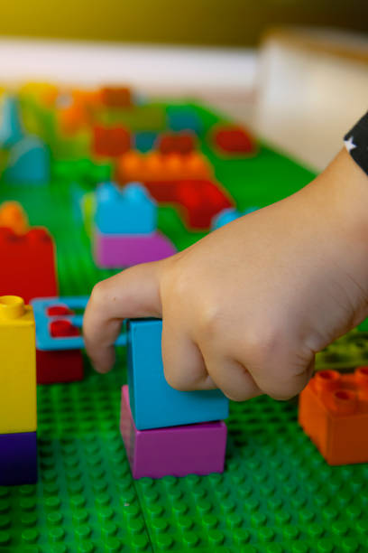 istock Little Girl Playing With Blocks At Library 1447446752