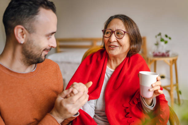 istock Volunteer Young Man Visiting Senior Lady for Emotional Support 1447446898