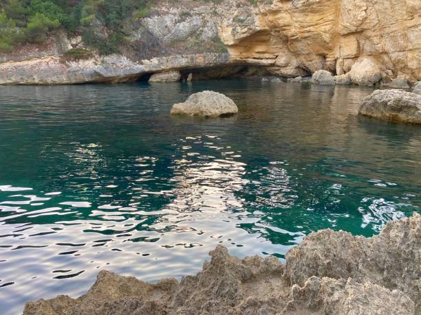 istock Rocks in the turquoise sea lagoon. 1447447203