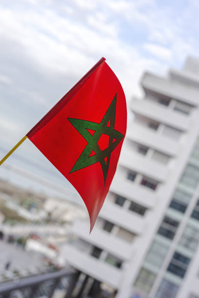istock Hands with flags of Morocco with defocused background 1447449972