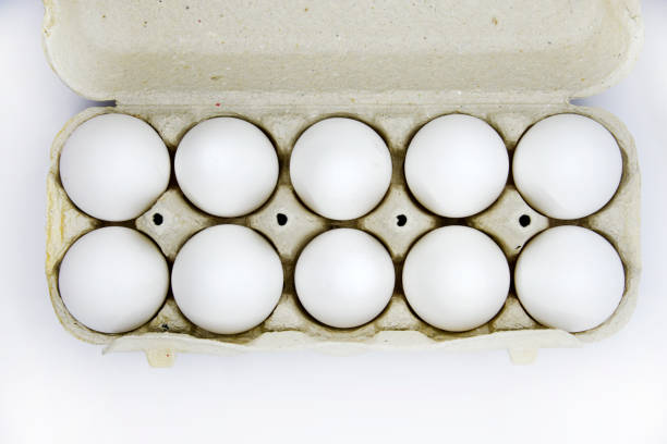 istock Fresh white chicken eggs in a paper bag. White eggs in a package on a white background. Eggs from the store. 1447450088